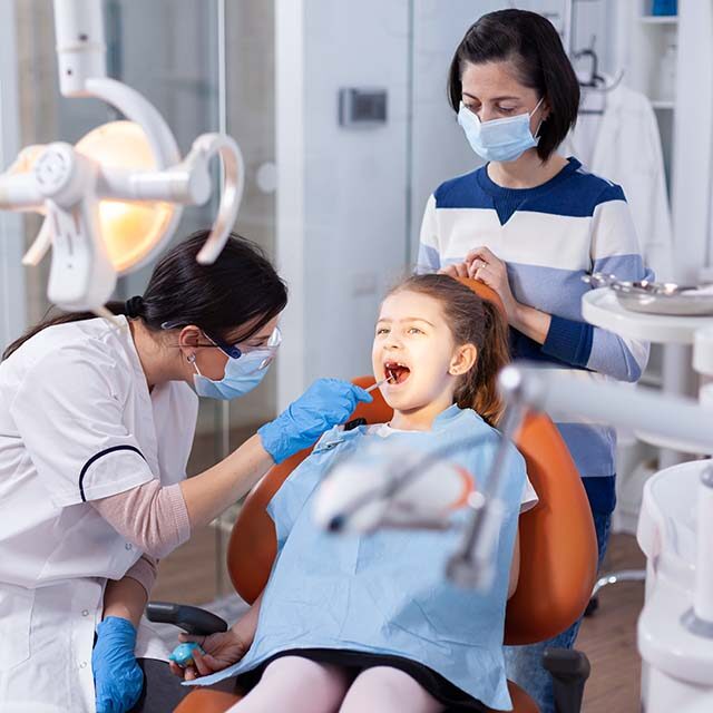 angled-mirror-used-by-dentist-doctor-little-girl-with-mouth-open-dental-office-dentistry-specialist-during-child-cavity-consultation-stomatology-office-using-modern-technology angled-mirror-used-by-dentist-doctor-little-girl-with-mouth-open-dental-office-dentistry-specialist-during-child-cavity-consultation-stomatology-office-using-modern-technology