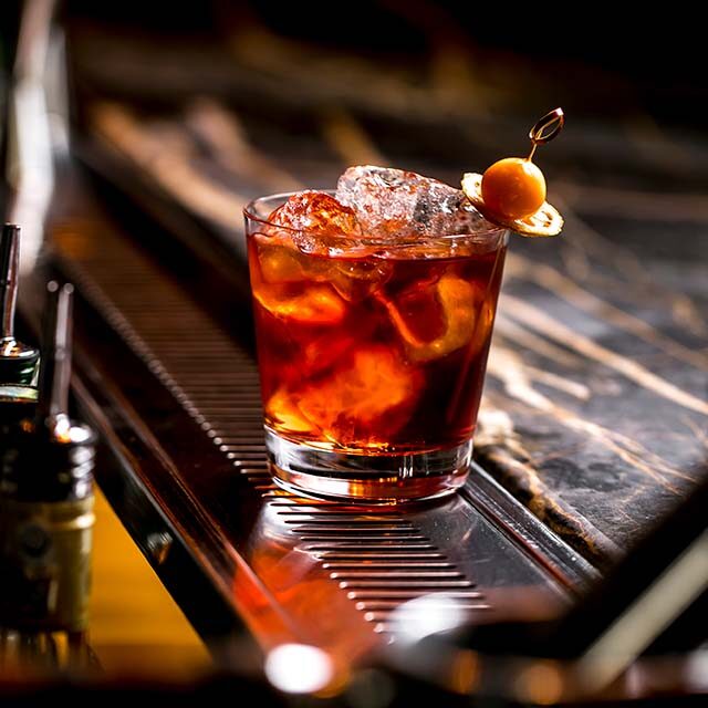 cocktail-glass-with-ice-cubes-garnished-with-dried-lemon-fruit cocktail-glass-with-ice-cubes-garnished-with-dried-lemon-fruit