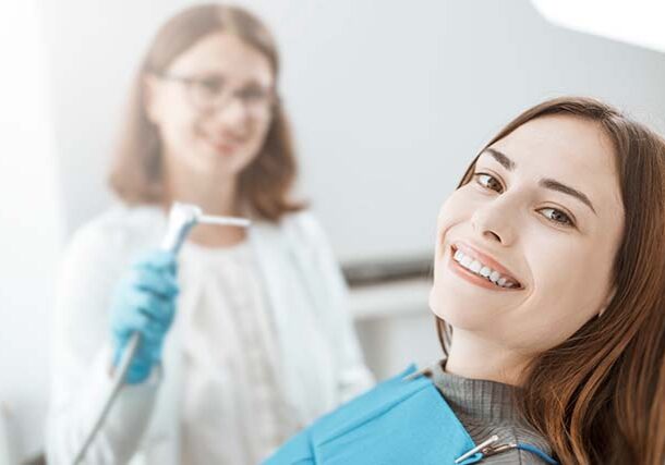 young-woman-sits-dental-chair-smiles-with-white-healthy-teeth young-woman-sits-dental-chair-smiles-with-white-healthy-teeth